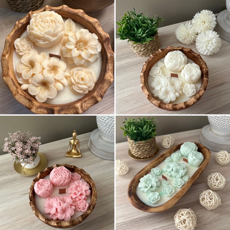 May include: Four wooden bowls with floral scented candles. The bowls are made of natural wood and have a rustic look. The candles are in various colors and shapes, including white, pink, and green.