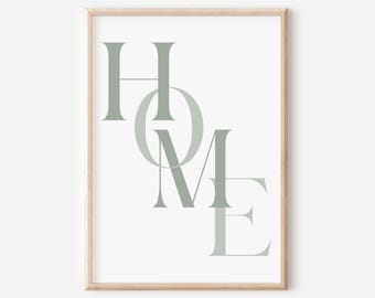 May include: A framed print with the word "HOME" in a light green color. The letters are stylized and overlap each other.