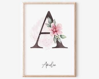 May include: A watercolor print featuring the letter A with pink flowers and green leaves. The name Amelie is written below the letter.