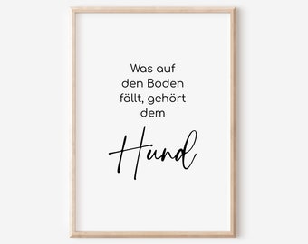May include: A black and white printable wall art print with the text "Was auf den Boden fällt, gehört dem Hund" in a simple, modern font.
