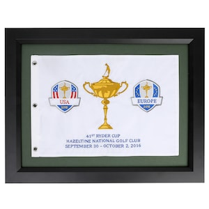 May include: A framed white flag with the Ryder Cup logo, the text "41st Ryder Cup", "Hazeltine National Golf Club", and "September 30 - October 2, 2016". The flag also features logos for the USA and Europe with the year 2016.