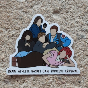 May include: A sticker featuring a group of five cartoon figures, with the text "BRAIN. ATHLETE. BASKET CASE. PRINCESS. CRIMINAL." at the bottom.