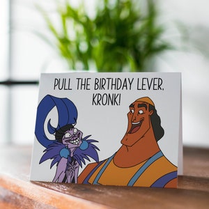 May include: A white card with a cartoon image of Kronk and Yzma from the Disney movie The Emperor's New Groove. The text on the card reads "Pull the birthday lever. Kronk!"