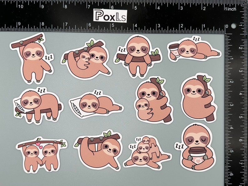 May include: A set of ten sloth stickers featuring various poses, including sleeping, holding a cup of coffee, and cuddling. The stickers are printed on white paper with a glossy finish.