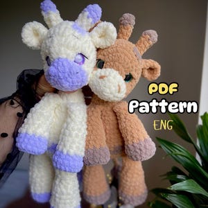 May include: Two handmade plush giraffe and cow toys. The cow is white with purple details, and the giraffe is tan with brown accents. The image includes the text "PDF Pattern ENG".