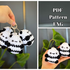 May include: Three black and white crocheted panda keychains with black eyes and a black nose. The keychains are attached to a silver chain and ring.  PDF Pattern ENG