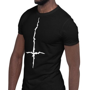 May include: A black t-shirt with a white upside-down cross graphic.