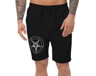 Puede incluir: Pantalones cortos deportivos negros con un diseño de pentagrama blanco. El pentagrama tiene una cabeza de cabra en su interior.
