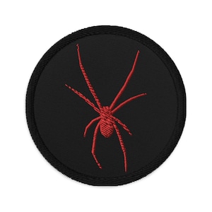 May include: Black embroidered patch with a red spider silhouette.