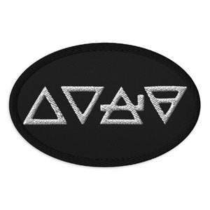 May include: Black oval patch with white embroidered symbols of the four elements: air, earth, fire, and water.