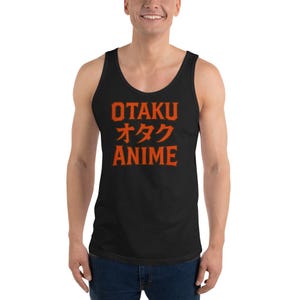 May include: Black tank top with the word "OTAKU" in orange block letters, followed by Japanese characters and the word "ANIME" in orange. The tank top is sleeveless and has a scoop neck.