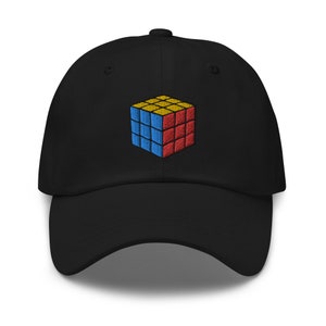 May include: A black baseball cap with an embroidered image of a colorful Rubik's Cube.