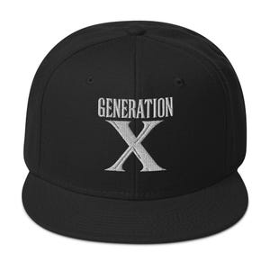 May include: Black baseball cap with a flat brim. The cap features the embroidered text "GENERATION X" in white, with a white "X" below. The cap has a structured crown and a flat brim.