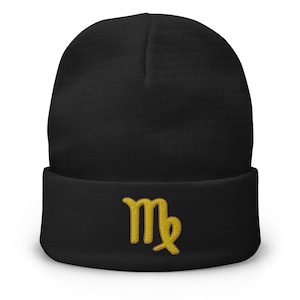 May include: Black knit beanie with a gold embroidered Virgo zodiac sign.