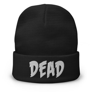 May include: Black beanie with a white embroidered word "DEAD" on the cuff.
