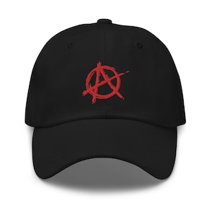 May include: A black baseball cap with a red anarchy symbol embroidered on the front.
