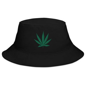 May include: Black bucket hat with a green marijuana leaf embroidered on the front.