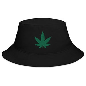 May include: A black bucket hat with a green marijuana leaf embroidered on the front.