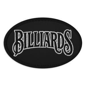 May include: An oval-shaped embroidered patch featuring the word "BILLIARDS" in white, decorative lettering against a black backdrop. The patch has a black border, suitable for sewing onto items.