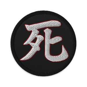 Peut inclure: Écusson brodé avec le symbole kanji japonais pour "mort" en blanc avec un contour rouge, sur un fond circulaire noir. L'écusson a une bordure noire et est conçu pour être cousu ou repassé sur du tissu.