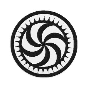 May include: Circular embroidered patch with a black and white spiral pattern. The design features a central spiral made of alternating black and white curved sections. A black border with pointed edges frames the spiral.