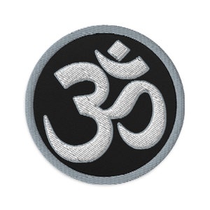 May include: A white embroidered Om symbol on a black circular patch with a gray border.