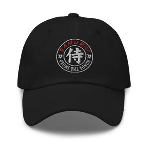 May include: Black baseball cap with an embroidered white circle containing the Japanese character "侍" (Samurai) in red, and the text "HONOR THE SWORD" in white.