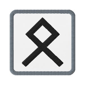 May include: Embroidered patch featuring a black rune symbol on a white background. The patch has a square shape with a gray border. The rune is a stylized geometric design.