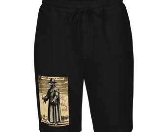 May include: Black shorts with a drawstring waist. The shorts feature a rectangular graphic of a plague doctor holding a staff, with the words "The Black Death" on the graphic. The graphic is in black and white.