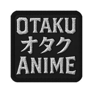 May include: Black embroidered patch with the words "OTAKU" and "ANIME" in white, with Japanese characters in the center. The patch has a square shape with a black border.