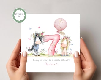 May include: A birthday card featuring a whimsical illustration of two cartoon horses with floral accents, a pink balloon, and the number 7. The card reads "happy birthday to a special little girl" and includes a name.