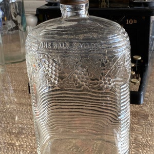 Ornate Clear Embossed one half gallon Wine Clear Bottle