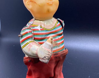 Vintage Tin Litho 1950’s Wind Up Baby Pulling Pants Down