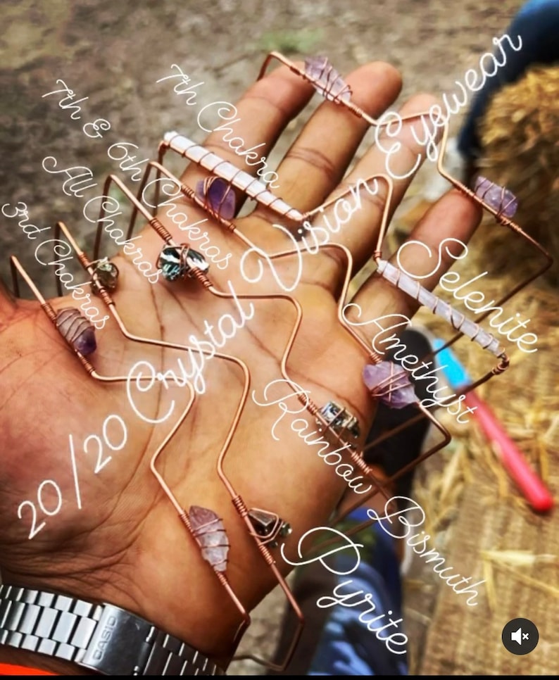 May include: A set of seven crystal wire-wrapped bracelets with various stones, including amethyst, selenite, rainbow pyrite, and bismuth. The bracelets are labeled with their corresponding chakras and the text "20/20 Crystal Vision Eyewear".