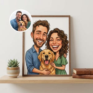May include: A framed cartoon portrait of a couple and their golden retriever dog. The couple is smiling, and the dog has its tongue out. A smaller inset image shows the couple with the dog. A small potted succulent and two leather-bound books are on the shelf.