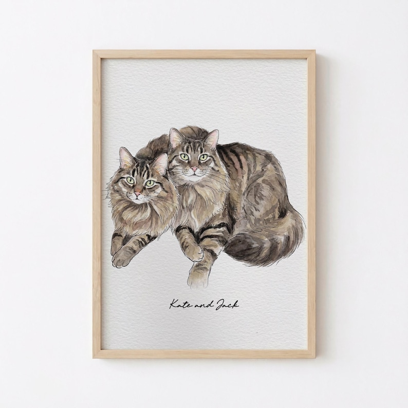 May include: Watercolor painting of two cats, one lying in front of the other. The cats have brown and black striped fur and green eyes. The text "Kate and Jack" is written in cursive at the bottom of the image.