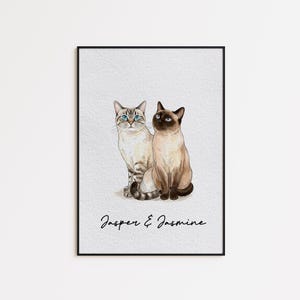 May include: Watercolor print of two Siamese cats, one with blue eyes and the other with dark eyes, sitting side-by-side. The print is framed in a black frame and features the names "Jasper & Jasmine" in script at the bottom.