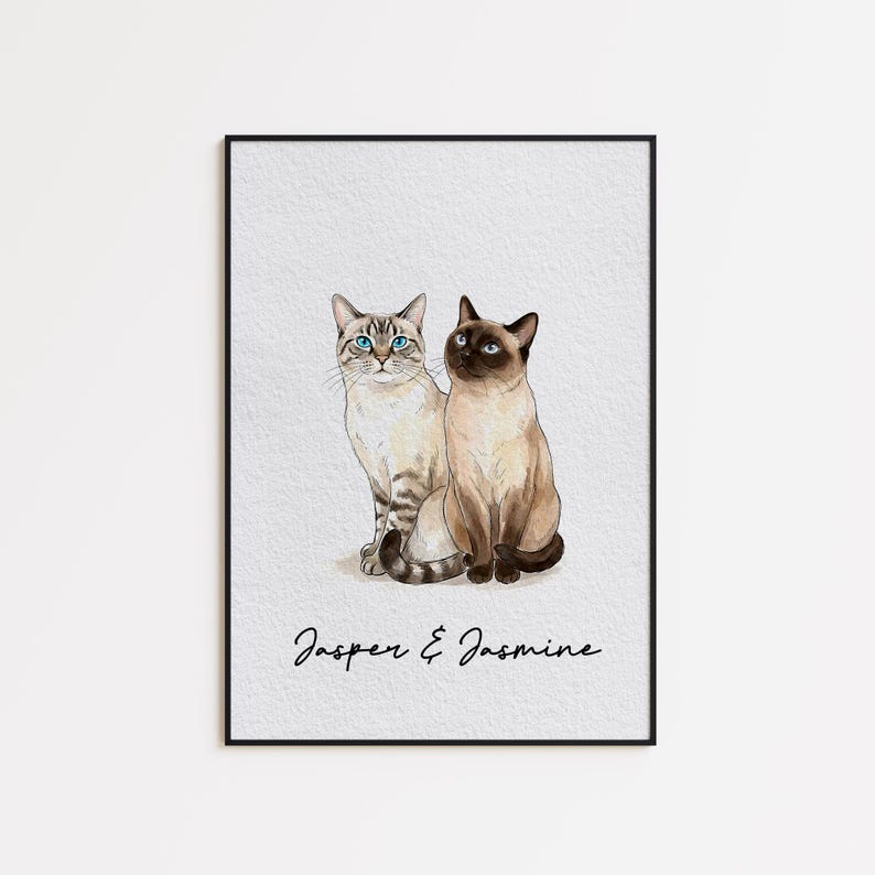 May include: Watercolor print of two Siamese cats, one with blue eyes and the other with dark eyes, sitting side-by-side. The print is framed in a black frame and features the names "Jasper & Jasmine" in script at the bottom.