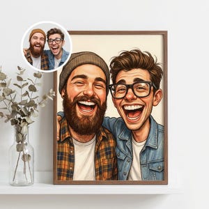 May include: A framed cartoon portrait of two laughing men, one with a beard and beanie, the other with glasses. The portrait is in a wooden frame, with a smaller inset image in the upper left corner. The background is a neutral color.