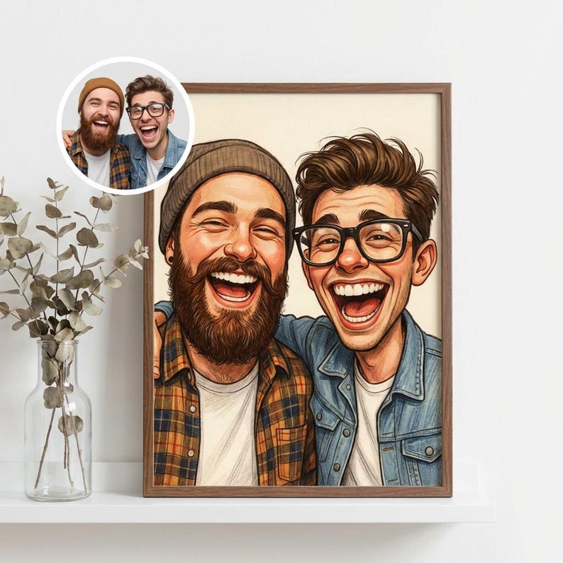 May include: A framed cartoon portrait of two laughing men, one with a beard and beanie, the other with glasses. The portrait is in a wooden frame, with a smaller inset image in the upper left corner. The background is a neutral color.