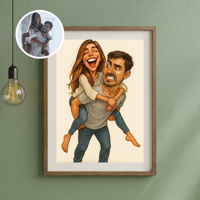 May include: A framed cartoon print depicts a woman laughing while being carried piggyback by a man with a surprised expression. The woman wears a white sweater and blue jeans. The man wears a gray shirt and blue jeans. A smaller inset image shows the couple in a photograph.
