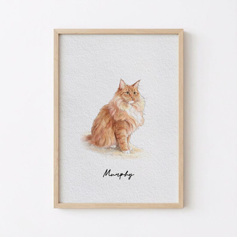 May include: Watercolor painting of a fluffy orange cat with white accents, sitting upright. The cat has long fur and a detailed depiction. The name "Murphy" is written in cursive below the cat. The artwork is framed in a light wood frame.