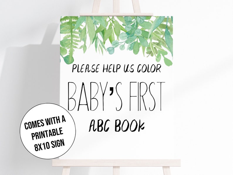 Może przedstawiać: Biały znak na sztaludze z napisem "PLEASE HELP US COLOR BABY'S FIRST ABC BOOK". Na g&oacute;rze znaku znajduje się akwarelowy wz&oacute;r zielonych liści. Mniejszy znak m&oacute;wi "COMES WITH A PRINTABLE 8X10 SIGN".