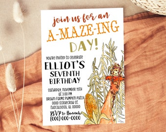 May include: A white invitation card with the text "join us for an A-MAZE-ING DAY!" in orange and green. The invitation is for Elliot's seventh birthday, with a watercolor illustration of a scarecrow and corn stalks.