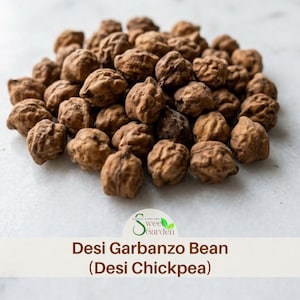May include: A pile of small, round, brown Desi garbanzo beans, also known as Desi chickpeas, with wrinkled, textured surfaces. Below the beans, a logo for Sweet Garden is visible, followed by the text Desi Garbanzo Bean (Desi Chickpea).
