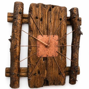 May include: Rustic wooden wall clock with a copper-colored square clock face and copper wire accents. The clock is framed by weathered wooden beams and logs, creating a natural, handcrafted aesthetic. The clock hands are copper-colored.