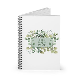 May include: White spiral-bound notebook with the text "GRAD SCHOOL NOTES" on the cover. The cover features a watercolour design of green leaves and foliage around a light green rectangular background.