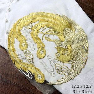 May include: Gold and silver embroidered phoenix applique with a circular design. The phoenix is surrounded by clouds. The applique is 12.2 inches by 12.2 inches or 31 cm by 31 cm.