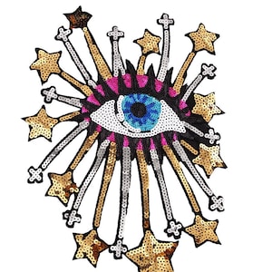 以下が含まれることがあります： 青い虹彩とピンクのまつげを持つ大きなカラフルな目。星の形をした金と銀のラメで囲まれています。