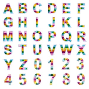 May include: A collection of embroidered alphabet letters and numbers. Each character is filled with a rainbow striped pattern and outlined in white. The letters and numbers are arranged in rows and columns against a white background.